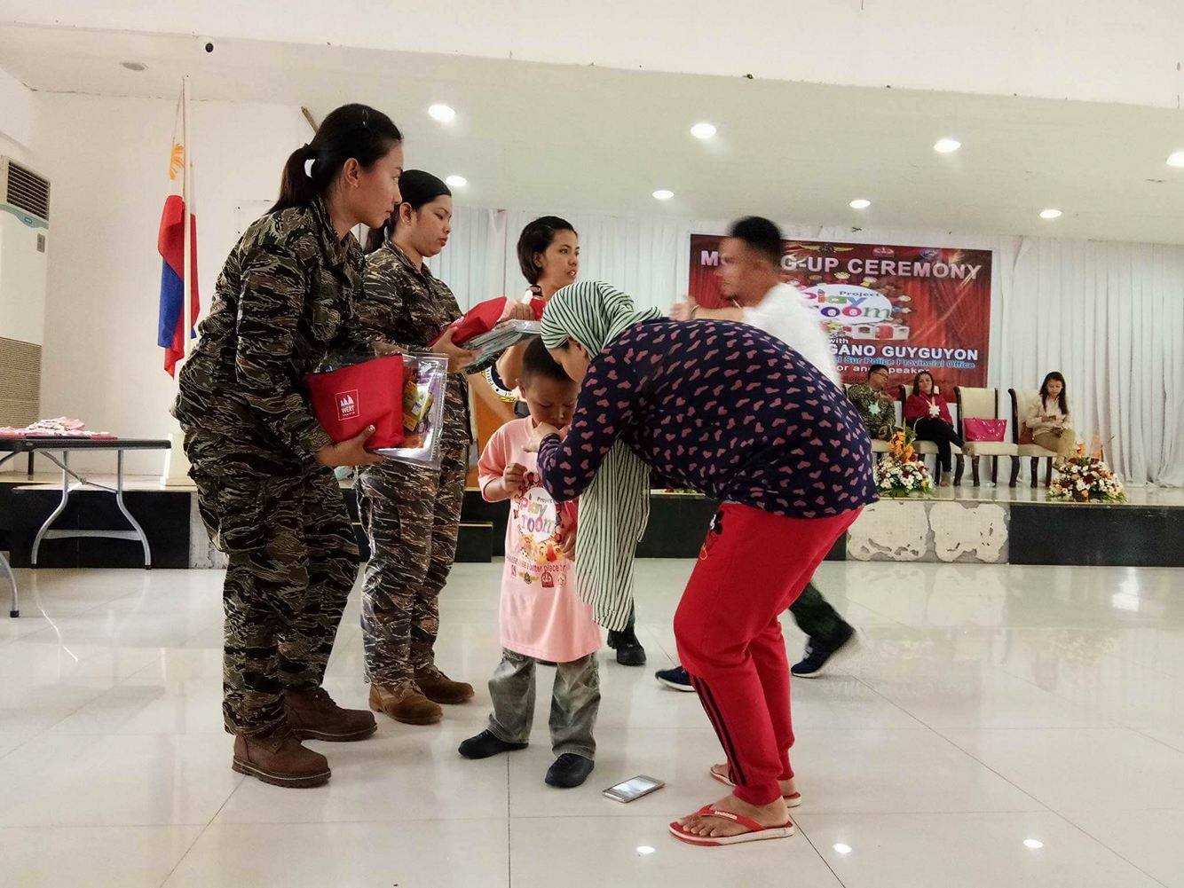 Military officers helped in distributing the Nutri10Plus Syrup and DayCee pouches to the kids